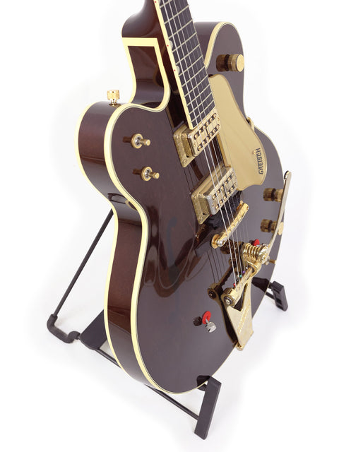 Exquisite Gretsch 6122T Chet Atkins guitar showcasing a classic brown body and striking gold hardware, a must-have for guitarists.