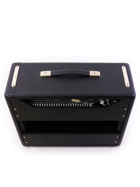 Fender '64 Custom Princeton Reverb amplifier in black, featuring a stylish metal cover on top, perfect for any music setup.
