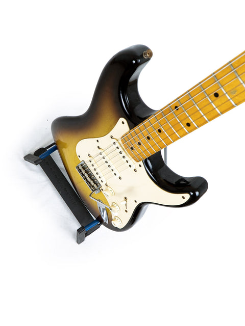 Fender Custom Shop Time Machine 58 Strat Relic guitar featuring a sleek black body and a contrasting white pickguard, USA 2008.