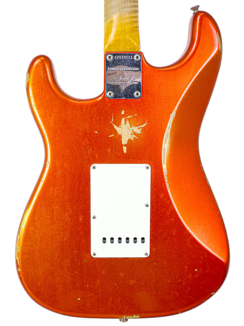 Fender Ltd NAMM '64 Stratocaster Relic in red with a white pickguard, exemplifying classic electric guitar craftsmanship.