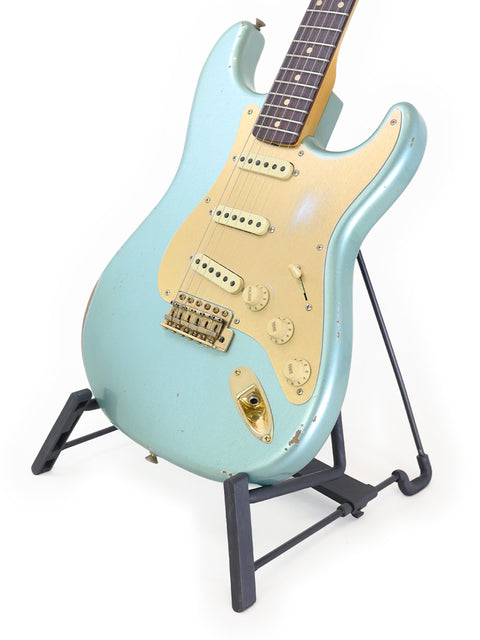Fender Stratocaster guitar resting on a stand, showcasing the 2020 USA Custom Shop Ltd Poblano Partscaster design.