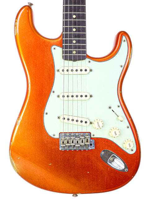 Fender guitar with an orange body and neck, model NAMM '64 Stratocaster Relic, USA, 2017.