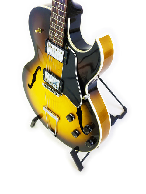 Gibson ES-135 guitar, made in the USA in 2001, positioned on a stand, emphasizing its vintage appeal.