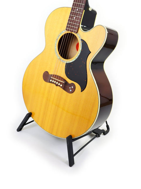 Gibson J-180EC guitar from 2001 displayed on a stand against a clean white background.