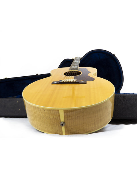 Gibson J-185-12 string guitar in a case, displayed on a white background, highlighting its craftsmanship and style.