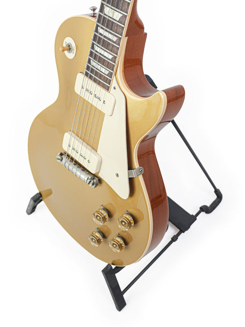 Gibson Les Paul Classic Gold guitar, model LPR-4 1954 Reissue, showcasing its iconic design and rich color.