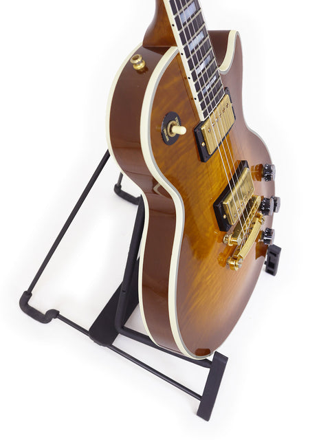 Gibson Les Paul Custom (USA, 1994) elegantly positioned on a stand with a plain white background.