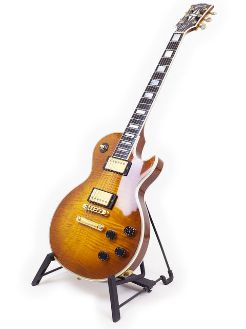 Gibson Les Paul Custom guitar from 1994 displayed on a stand against a clean white background.
