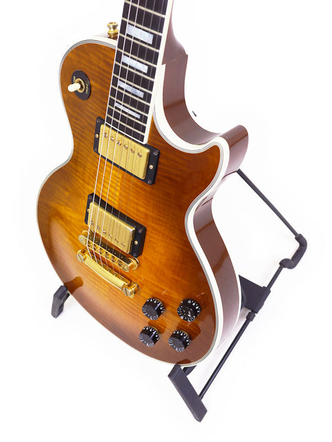 Gibson Les Paul Custom guitar on a stand, set against a clean white background, showcasing its elegant design.