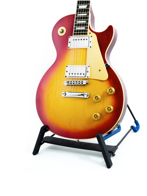 Gibson Les Paul Standard guitar from 1998 displayed on a stand against a clean white background.