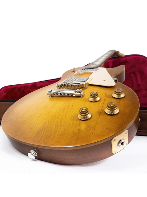 Gibson Les Paul Tribute guitar in its case, displayed against a clean white background, showcasing its elegant design.