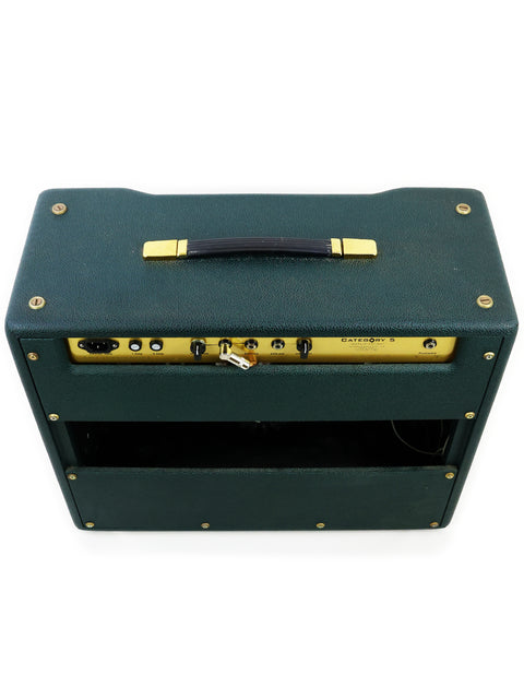 Green guitar amplifier with gold accents, representing the Category 5 Ivan Combo Amplifier, made in the USA in 2012.