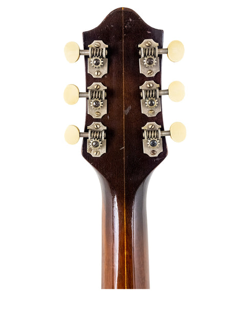 Headstock of a 1935 Vintage Epiphone Masterbilt Zenith acoustic guitar, highlighting its classic craftsmanship and design.