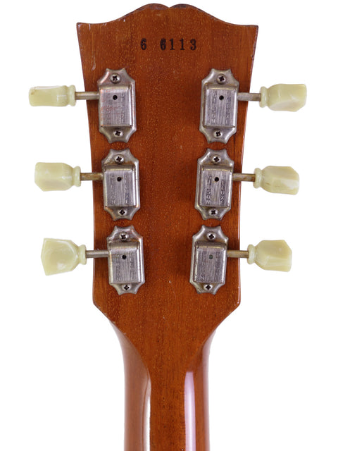 Headstock of a Gibson Custom Shop 1956 Les Paul with four knobs, showcasing its classic design and upgraded features.
