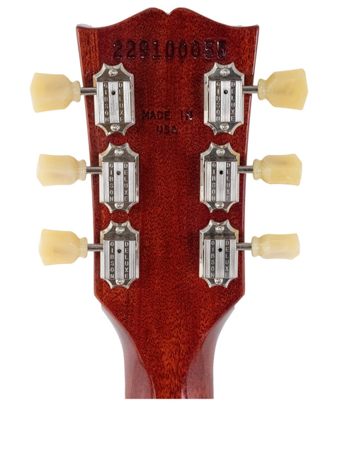 Headstock of a Gibson Standard ’61 SG electric guitar featuring four knobs, showcasing its classic design and craftsmanship.
