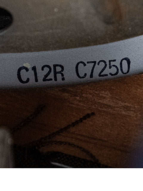Image focusing on the label of a 1952 Fender Tweed 5B3 Deluxe, set against a wooden background, showcasing its vintage style.