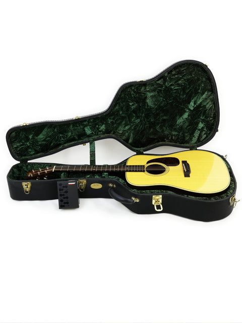 Inside a Collings D2H guitar case, a striking yellow guitar is prominently displayed, highlighting its craftsmanship and color.