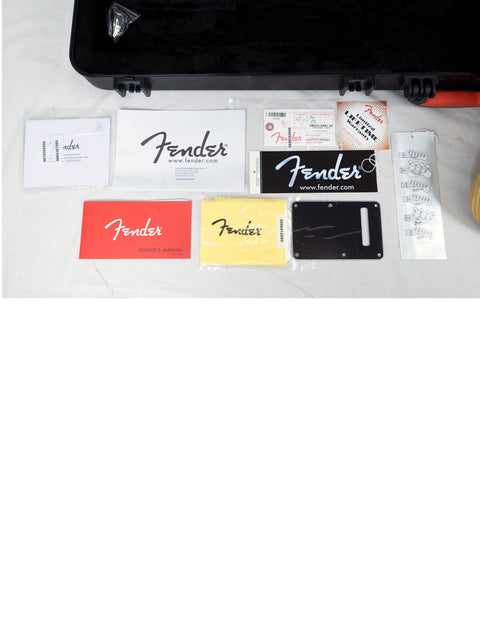 Inside a Fender guitar case, accessories and a Limited Edition 2015 Natural Oiled Ash Stratocaster are displayed.