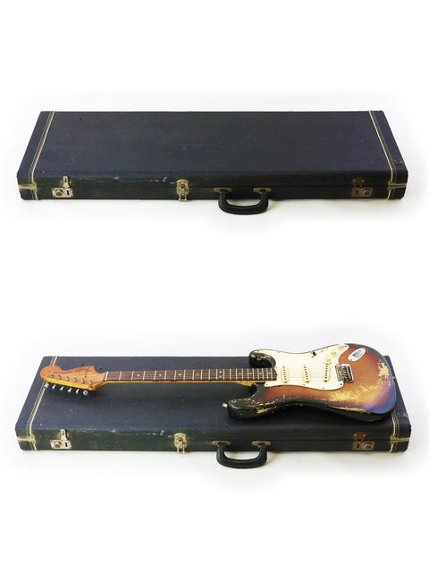 Inside a case, a vintage 1970 Fender Stratocaster and another guitar rest side by side, ready for their next performance.

