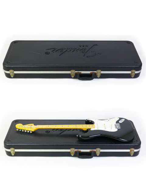 Inside a case, two black and yellow vintage Fender Stratocaster guitars from 1981 await their next performance.