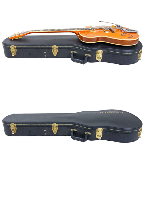 Inside a case, two guitars are displayed, one being a Gretsch Roundup 6121W Reissue from Japan, 2003.