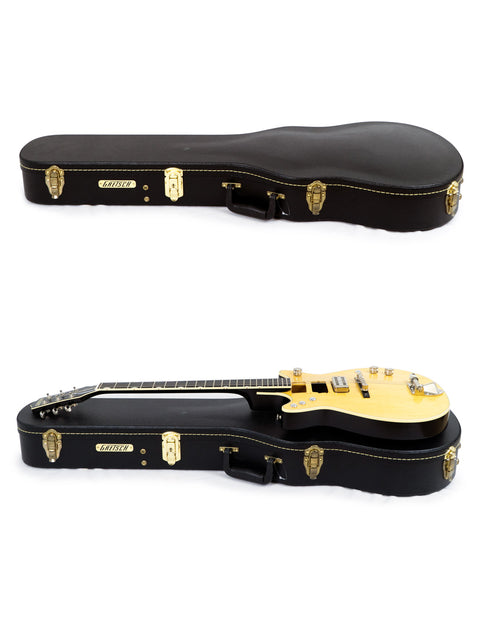 Inside a case, two guitars with gold hardware are displayed, one being the Gretsch G6131 Malcolm Young Signature Jet from Japan, 2020.