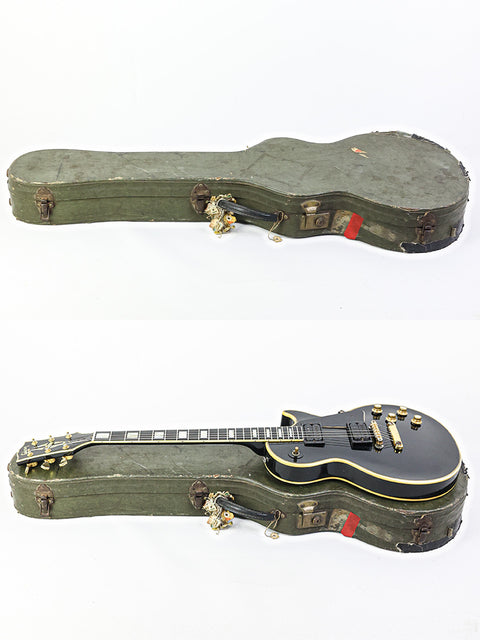 Inside a green case, two guitars are displayed, one being a vintage 1969 Gibson Les Paul Custom from the USA.