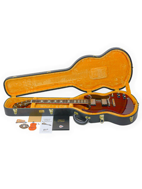 Inside a guitar case, a Gibson Custom Shop '64 SG Standard guitar rests, highlighting its vintage style and premium quality.