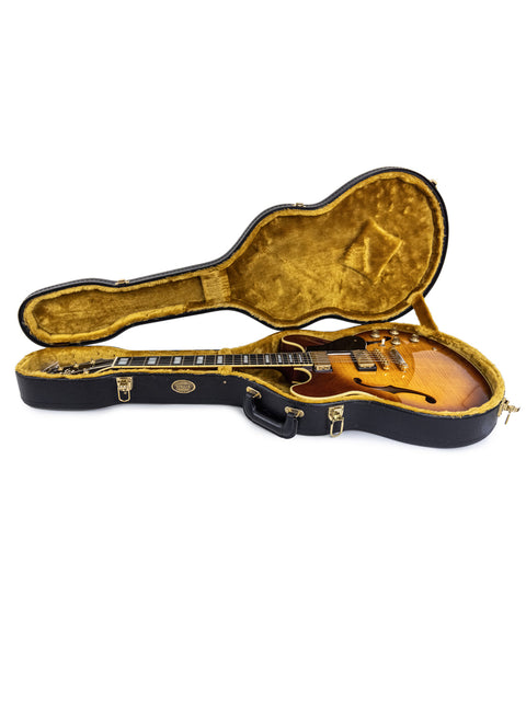 Inside a guitar case, a Yamaha SA 2200 Thinline from Japan, 2004, rests, highlighting its elegant shape and style.