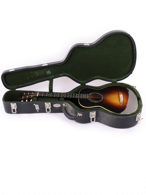 Inside a guitar case lies a Beau Hannam Parlour acoustic guitar, made in Australia in 2009, highlighting its beautiful craftsmanship.