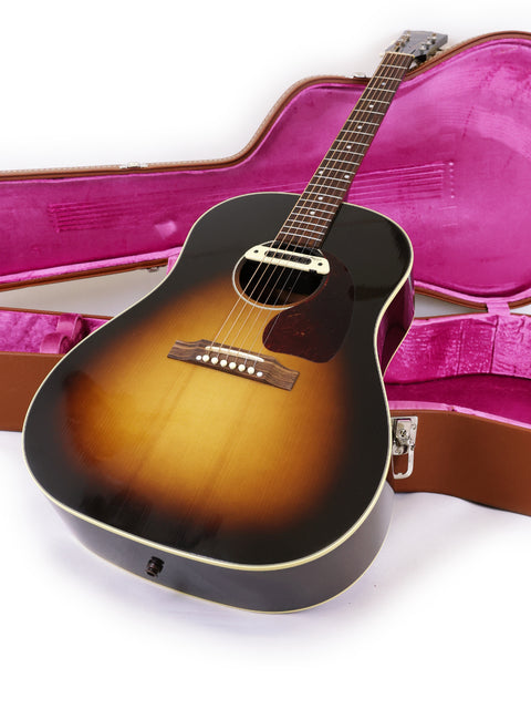 Inside a pink case lies a Gibson J-45 True Vintage guitar, a stunning instrument crafted in the USA in 2012.