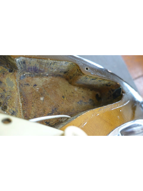 Inside a vintage 1963 L Series Stratocaster guitar, featuring a broken neck and detailed craftsmanship.