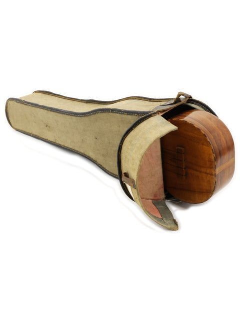 Inside a wooden guitar case lies a Royal Style 3 Koa Ukulele, a piece from Hawaii dating back to 1916.