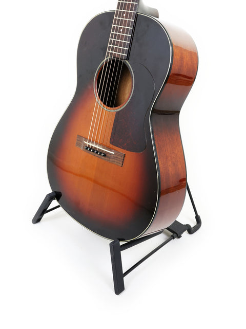 K. Yairi G-1F guitar displayed on a stand, set against a bright white background, highlighting its craftsmanship from Japan, 2005.