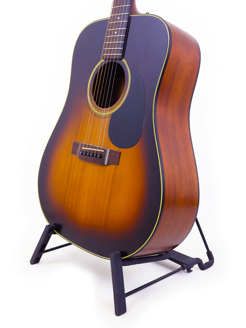  K. Yairi W1S guitar from 1983, elegantly positioned on a stand with a simple white backdrop.