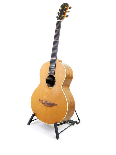 Lowden S-35 prototype guitar on a stand, set against a white backdrop, highlighting its craftsmanship from Ireland, 2018.