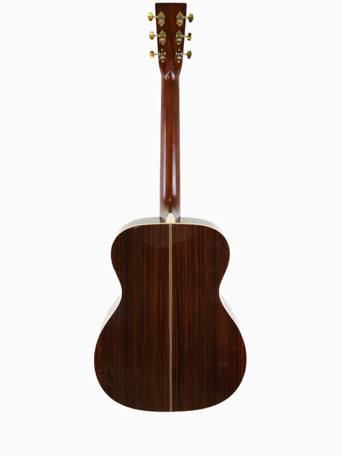 Martin 000-28 Modern Deluxe acoustic guitar's back displayed on a clean white background.