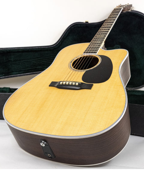 Martin DC Aura GT Dreadnought guitar nestled in a stylish black case, highlighting its premium quality and 2019 USA craftsmanship.