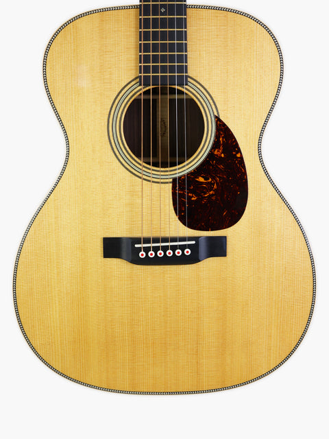 Martin Luther King Jr. holding a Martin 000-28 Modern Deluxe acoustic guitar, symbolizing his passion for music and justice.