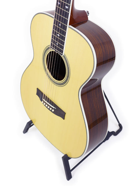 Maton Custom Shop Classic acoustic guitar on a stand, a compact instrument from Australia, crafted in 2020.