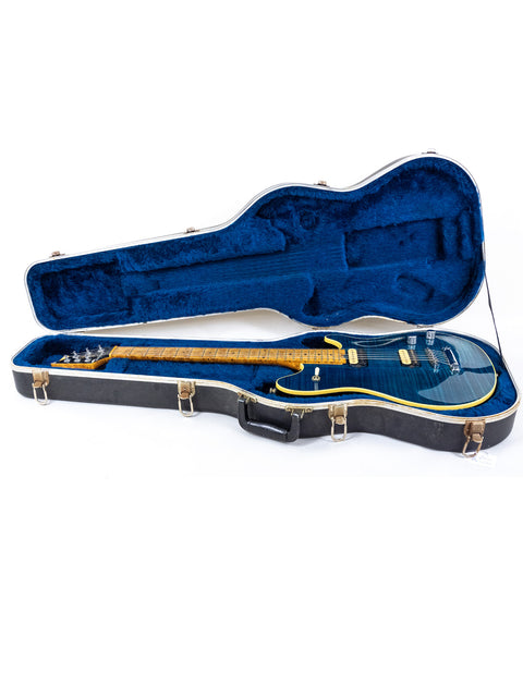Open blue guitar case showcasing a black Peavey EVH Wolfgang Standard Hardtail guitar from 1999.