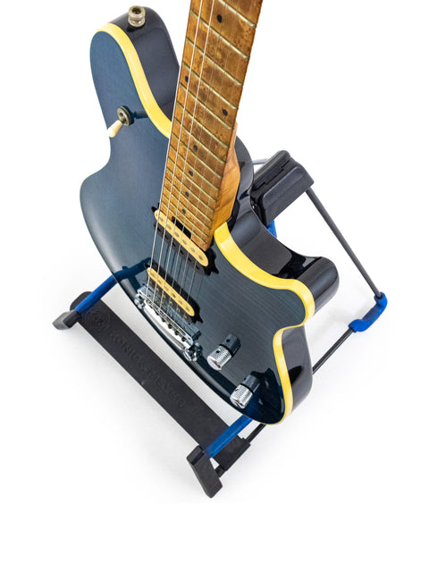 Peavey EVH Wolfgang Standard Hardtail guitar in blue and black, elegantly positioned on a stand for display.