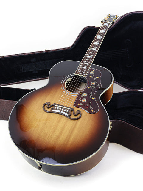 Premium Gibson SJ-200 guitar resting in its case, perfect for buyers seeking top-notch craftsmanship and sound quality.