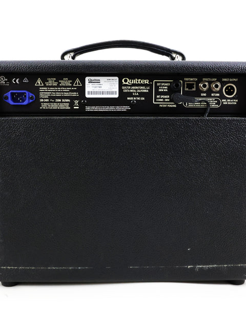 Rear perspective of a black amplifier with a blue logo, titled Quilter Aviator Gold 8” Combo – USA 2018.