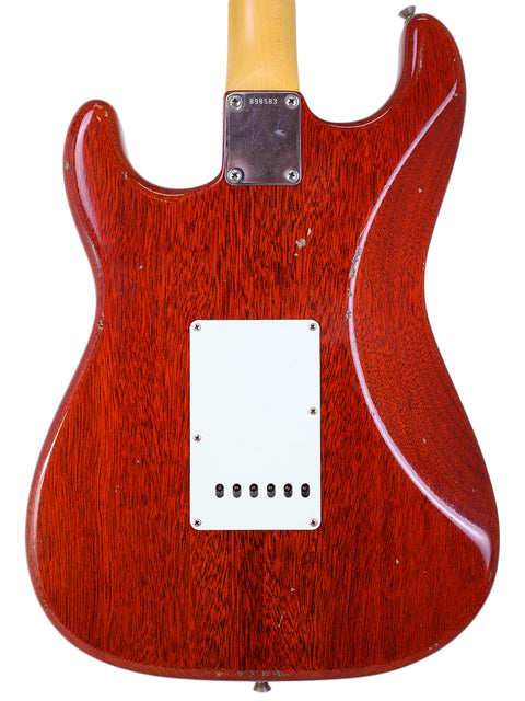 Rear perspective of a red 2019 Fender Custom Shop Stratocaster with a white pickguard, showcasing its distinctive relic style.