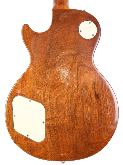 Rear side of a 1973 Gibson Les Paul Deluxe guitar showcasing its white pickguard.