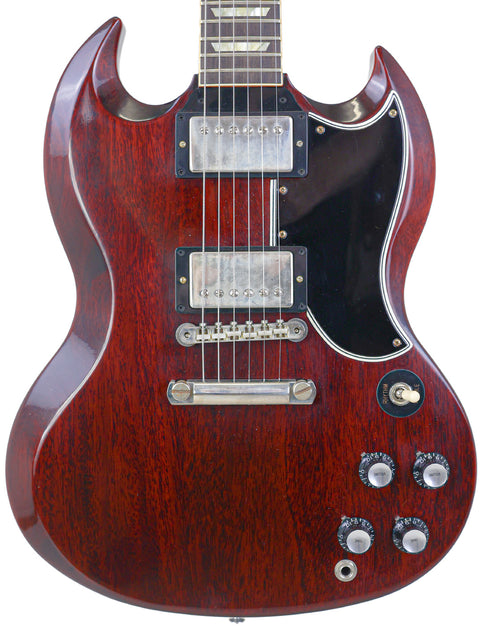 Red electric guitar featuring a black pickguard, representing the Gibson Custom Shop '64 SG Standard - USA 2020 model.