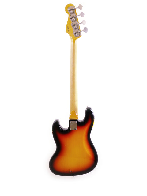 Small yellow guitar with a black neck, showcasing the Fender Custom Shop '64 Jazz Bass Relic from 2006.