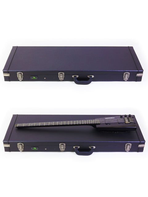 Stacked guitar cases: a black one on top of a blue one, with a vintage Steinberger L2 Bass from 1982.
