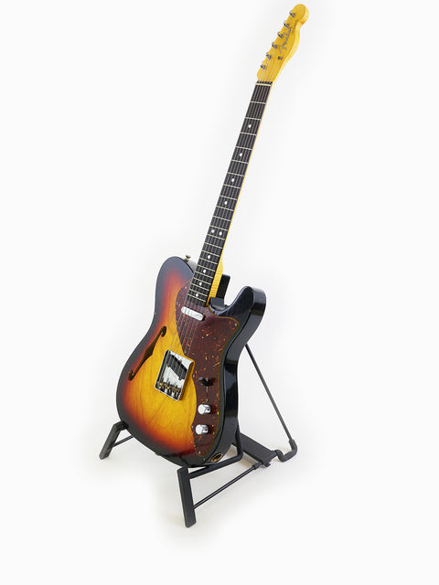 Sunburst-finished Fender Limited Edition ’60s Telecaster Thinline Journeyman Relic guitar displayed on a stand.